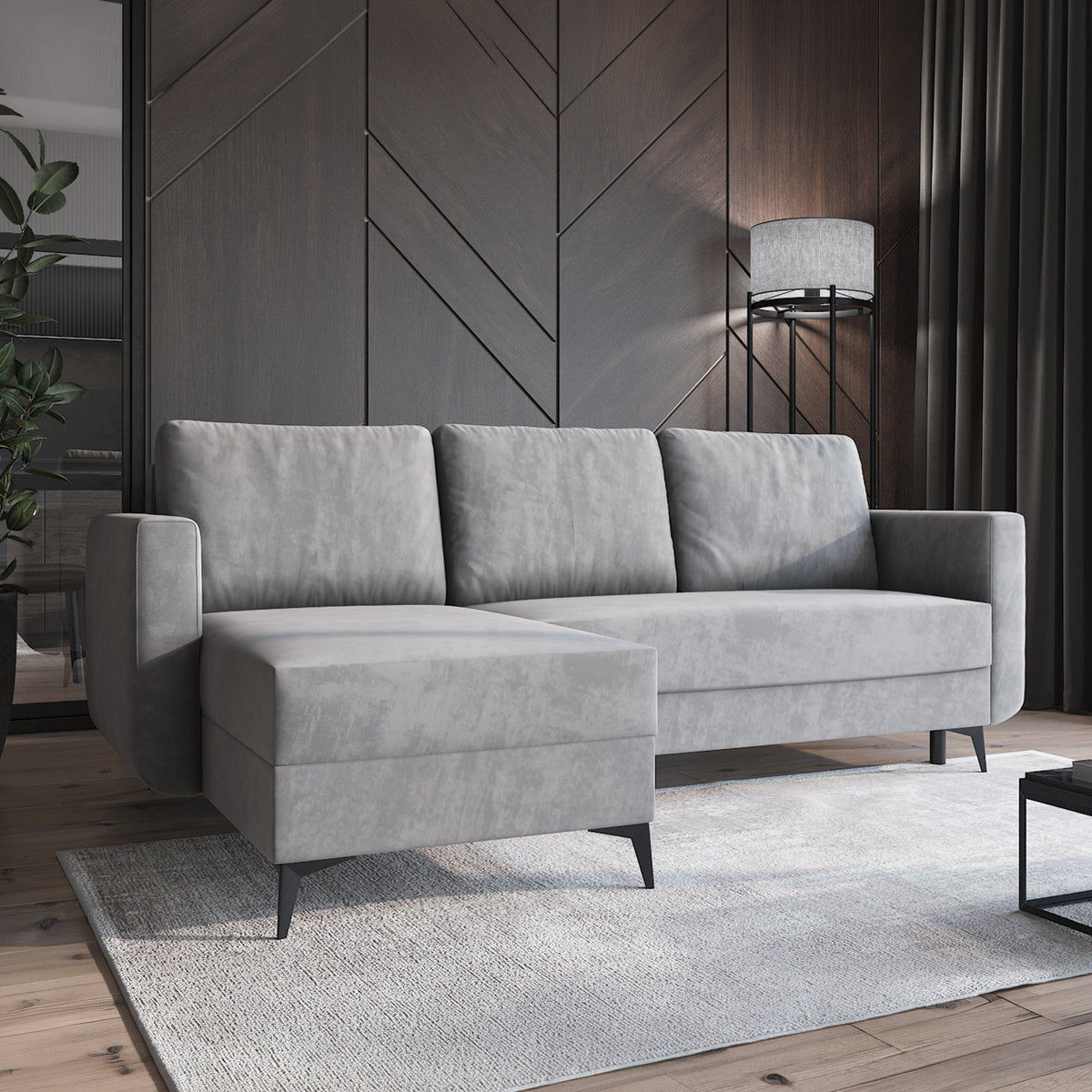 Forra-hjørnesofa, stålgrå (MANILA 16), i en moderne stue med tæppe og lampe, chaiselong til venstre